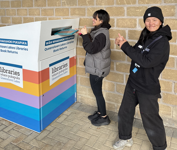 Paetara staff demonstrating new library book drop location at Paetara in Wanaka